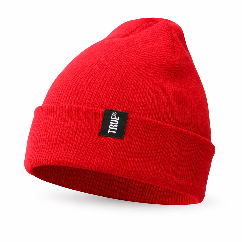 Bonnet en coton gris plié sur un fond uni