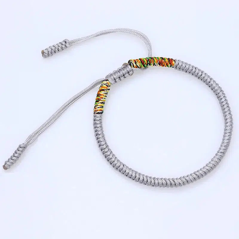 Bracelet bouddhiste argenté avec nœud tressé artisanalement