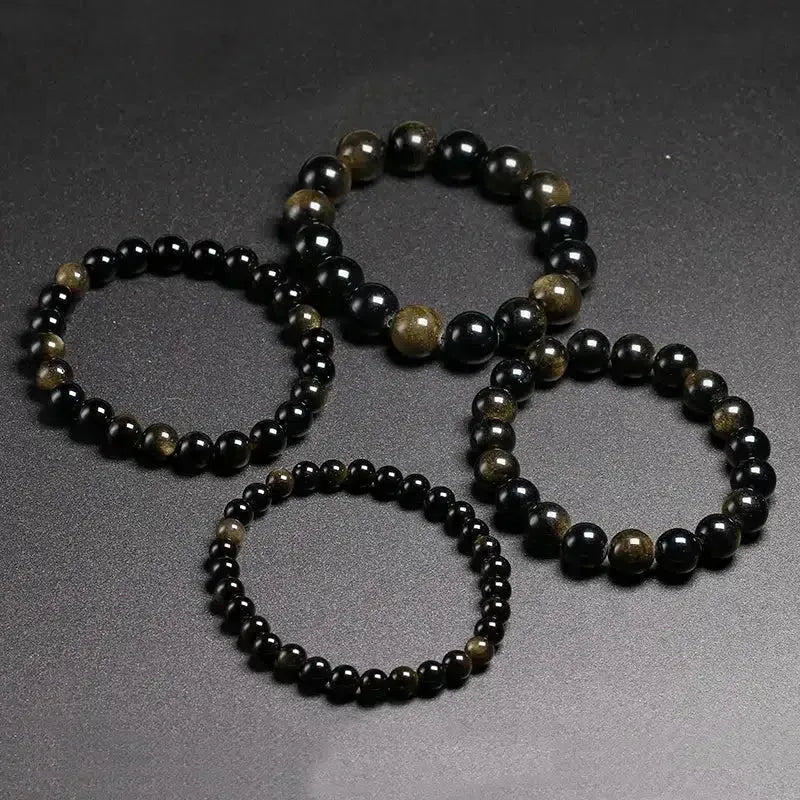Détail des perles brillantes en obsidienne œil céleste