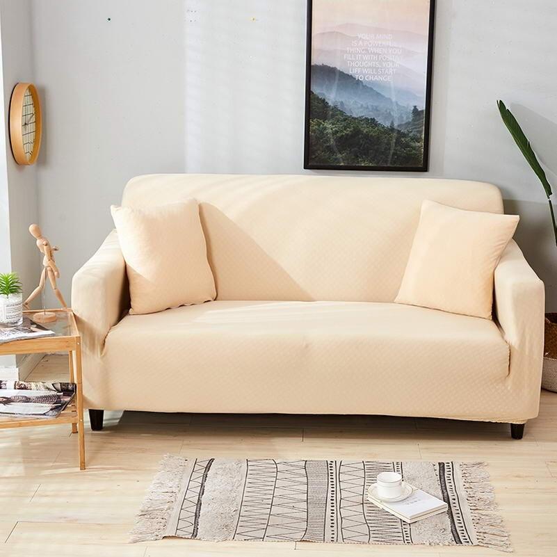 Housse de coussin beige et rose sur canapé