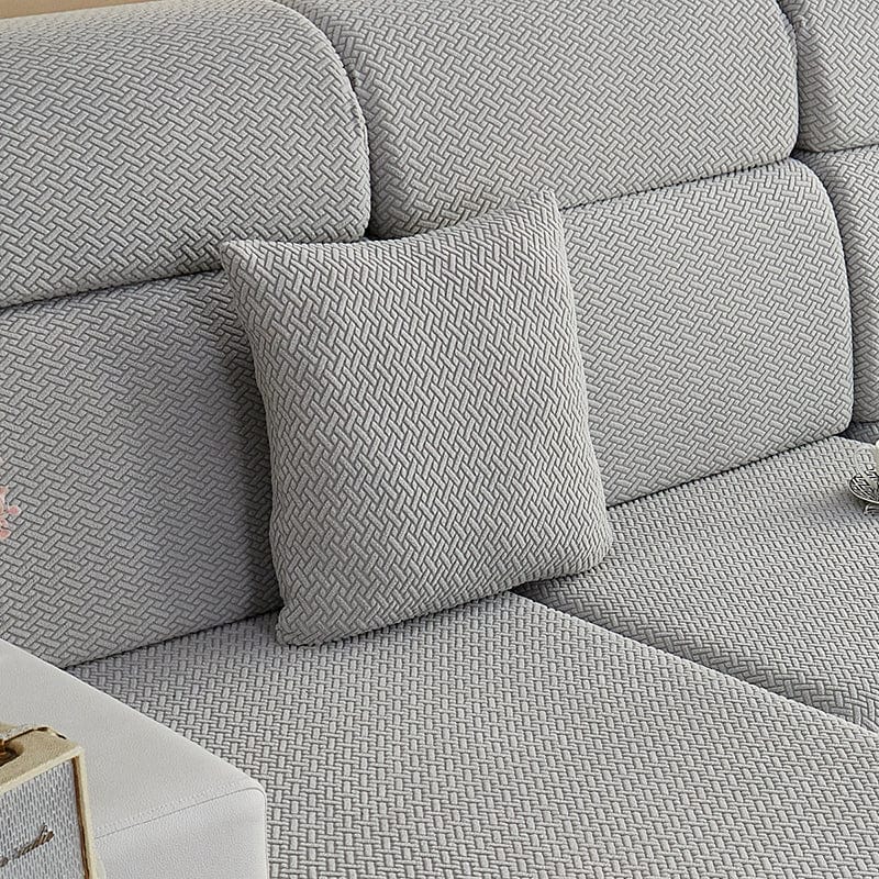 Housse de coussin gris clair en laine avec texture visible