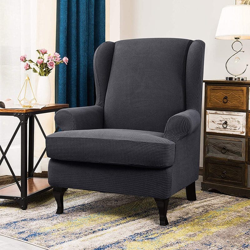 Housse grise sur fauteuil à oreilles, tissu jacquard extensible