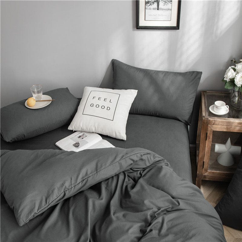 Présentation complète de l'ensemble de draps gris sur un lit