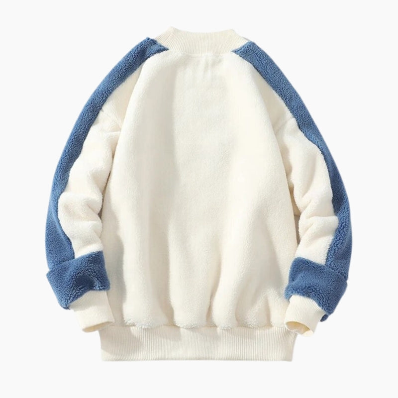 Pull blanc et bleu avec motif géométrique sur la poitrine