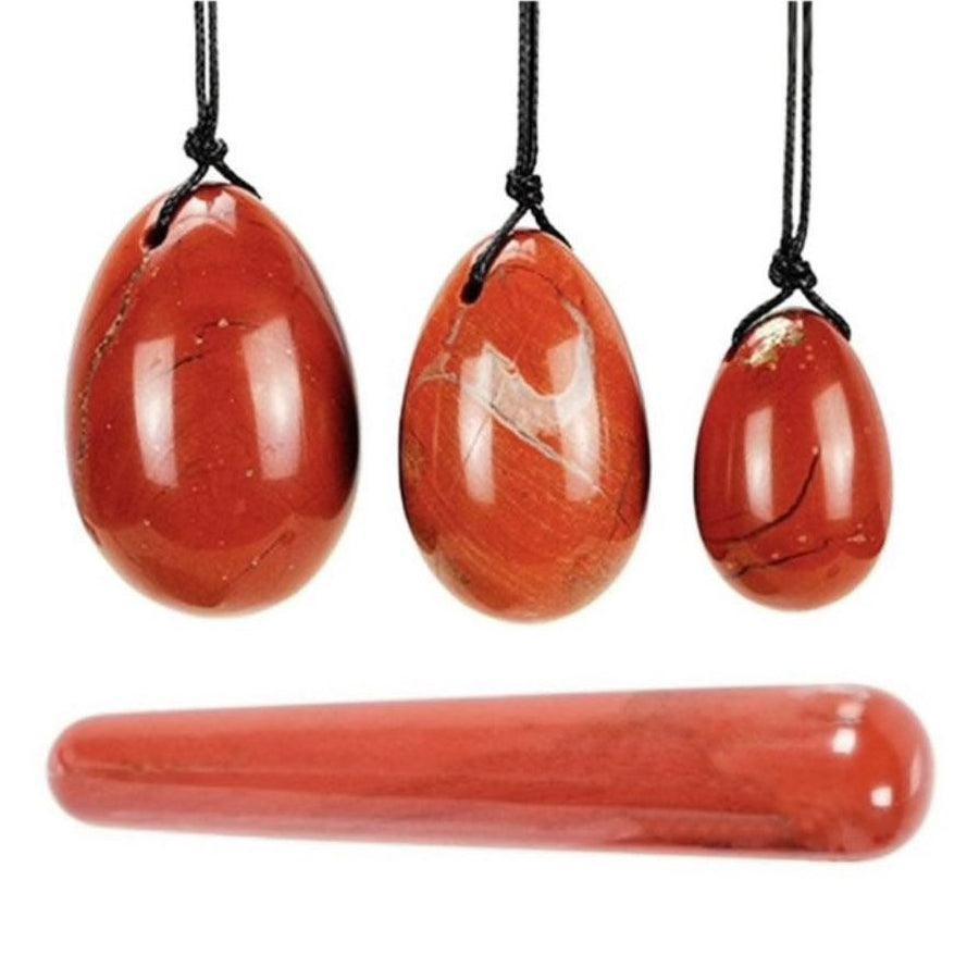 Trois œufs de Yoni en jaspe rouge sur fond blanc