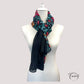 Foulard noir étalé, motifs floraux multicolores bien visibles
