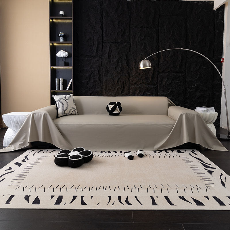 Jeté de canapé en simili cuir beige sur un canapé gris
