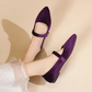 Ballerines en velours posées sur une surface en bois