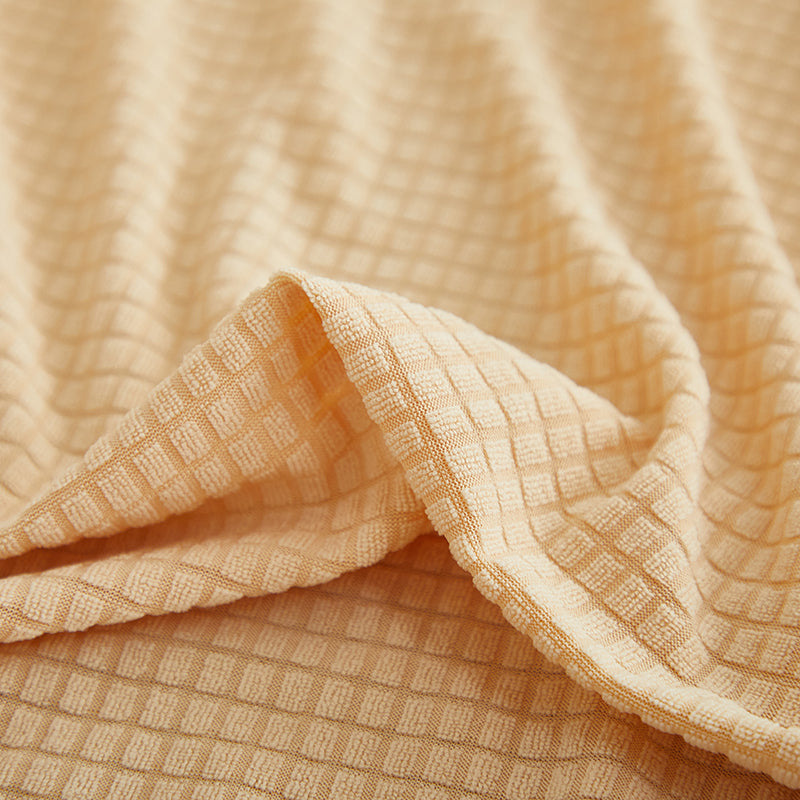 Housse beige extensible sur canapé panoramique