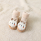 Chaussures chaussettes bébé beiges avec design lapin