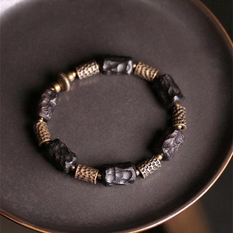 Bracelet artisanal en bois d'ébène et cuivre martelé