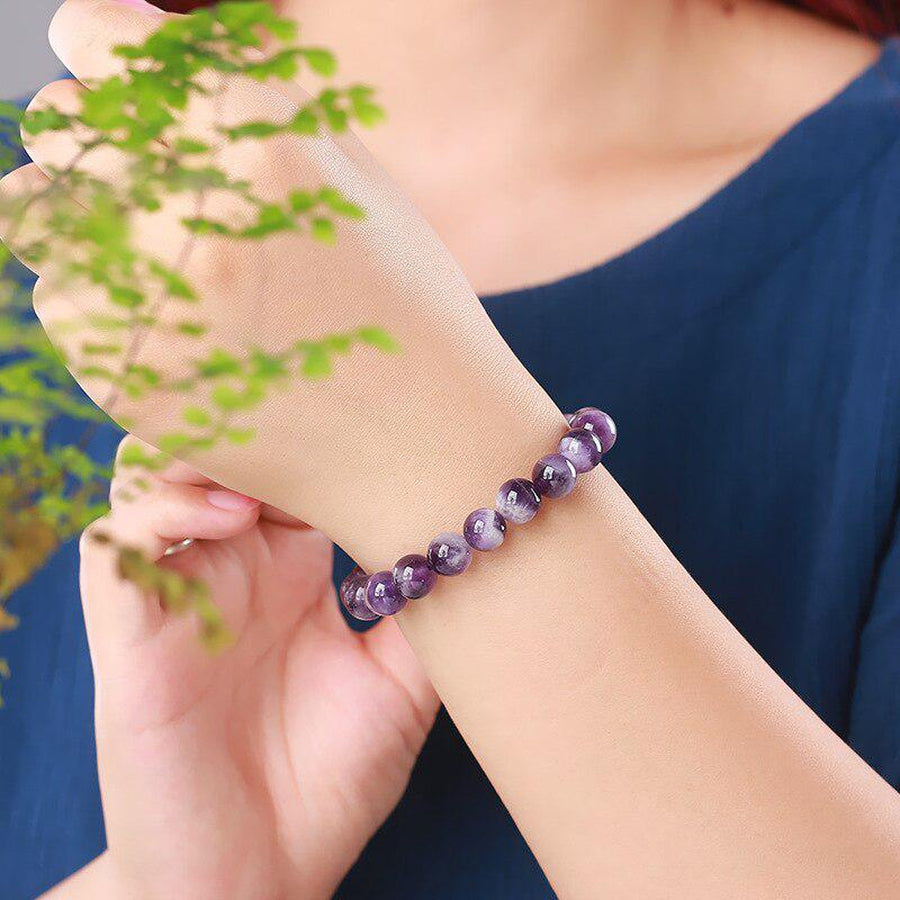Bracelet en perles de cristal violet sur fond blanc