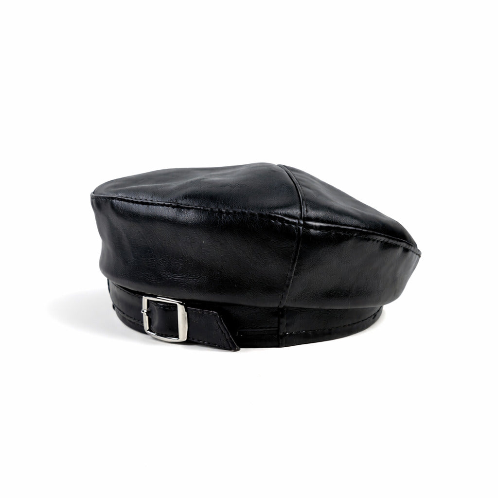 Béret en cuir posé sur une table en bois clair