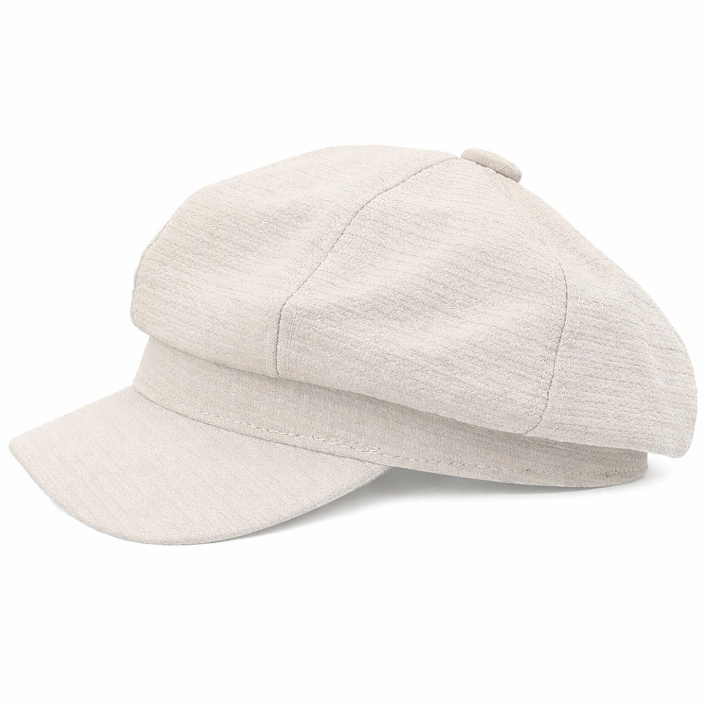 Gros plan sur la texture en tweed d'une casquette gavroche