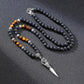 Collier avec pendentif poignard, perles de lave et œil de tigre