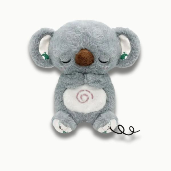 Petite fille endormie avec veilleuse koala apaisante