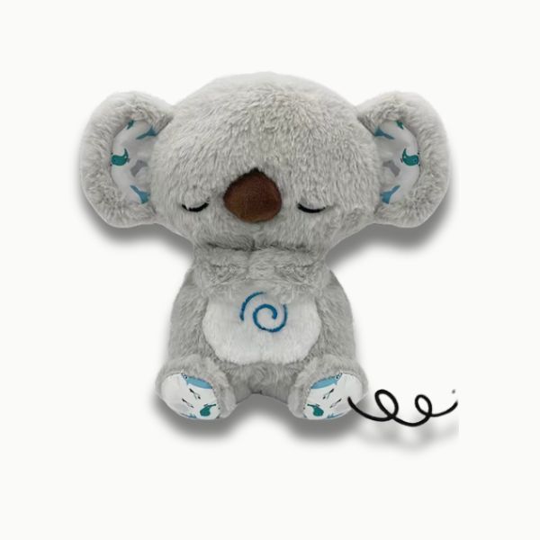 Petit garçon apaisé par veilleuse musicale koala