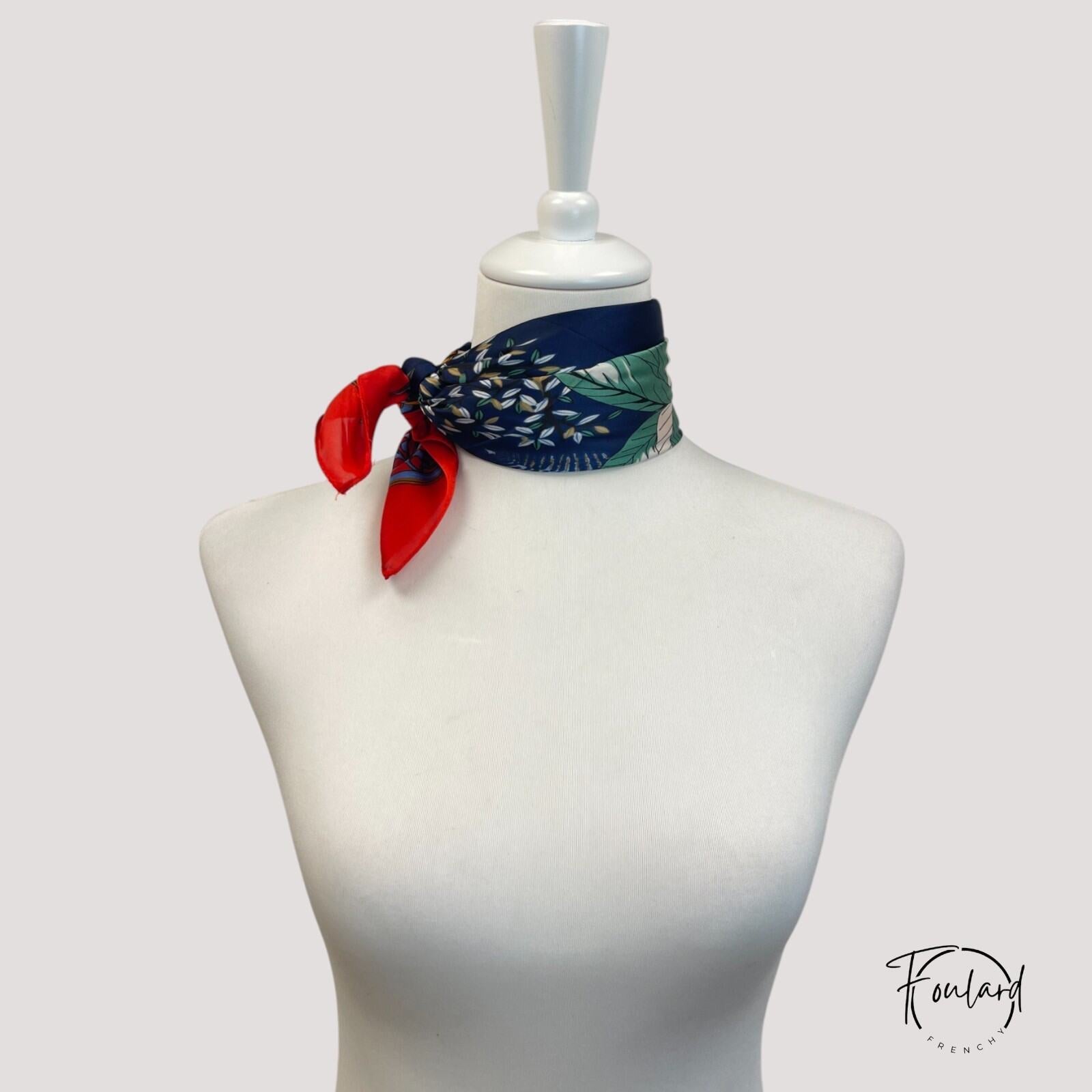 Vue rapprochée des motifs dorés et verts du foulard