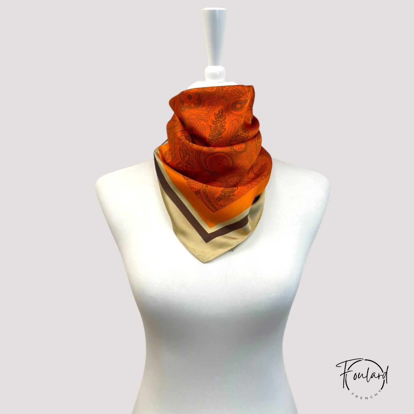 Foulard carré noué, montrant sa fluidité et ses couleurs vives
