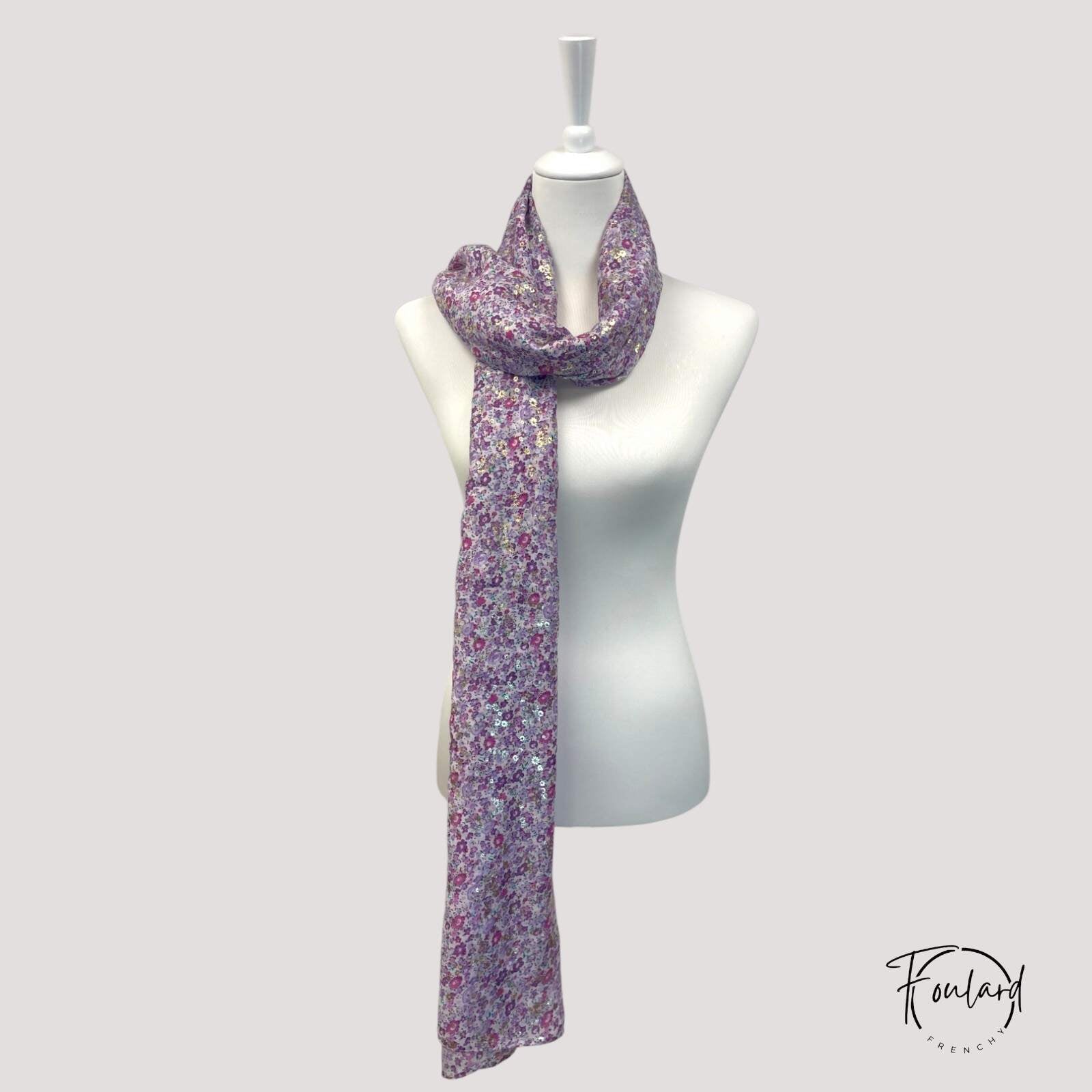 Détail des fleurs lilas sur fond violet avec éclats dorés