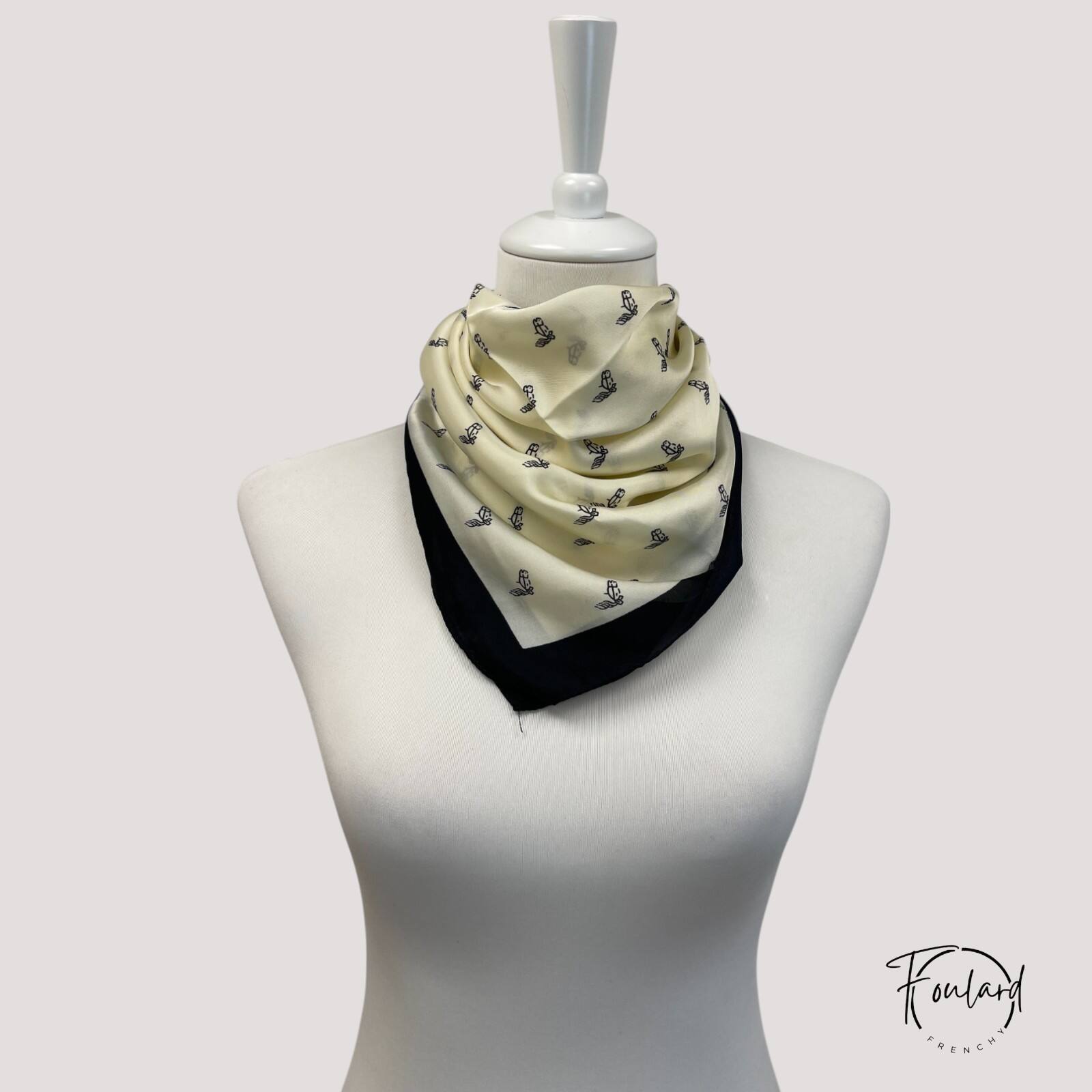 Foulard blanc carré posé sur une surface en bois