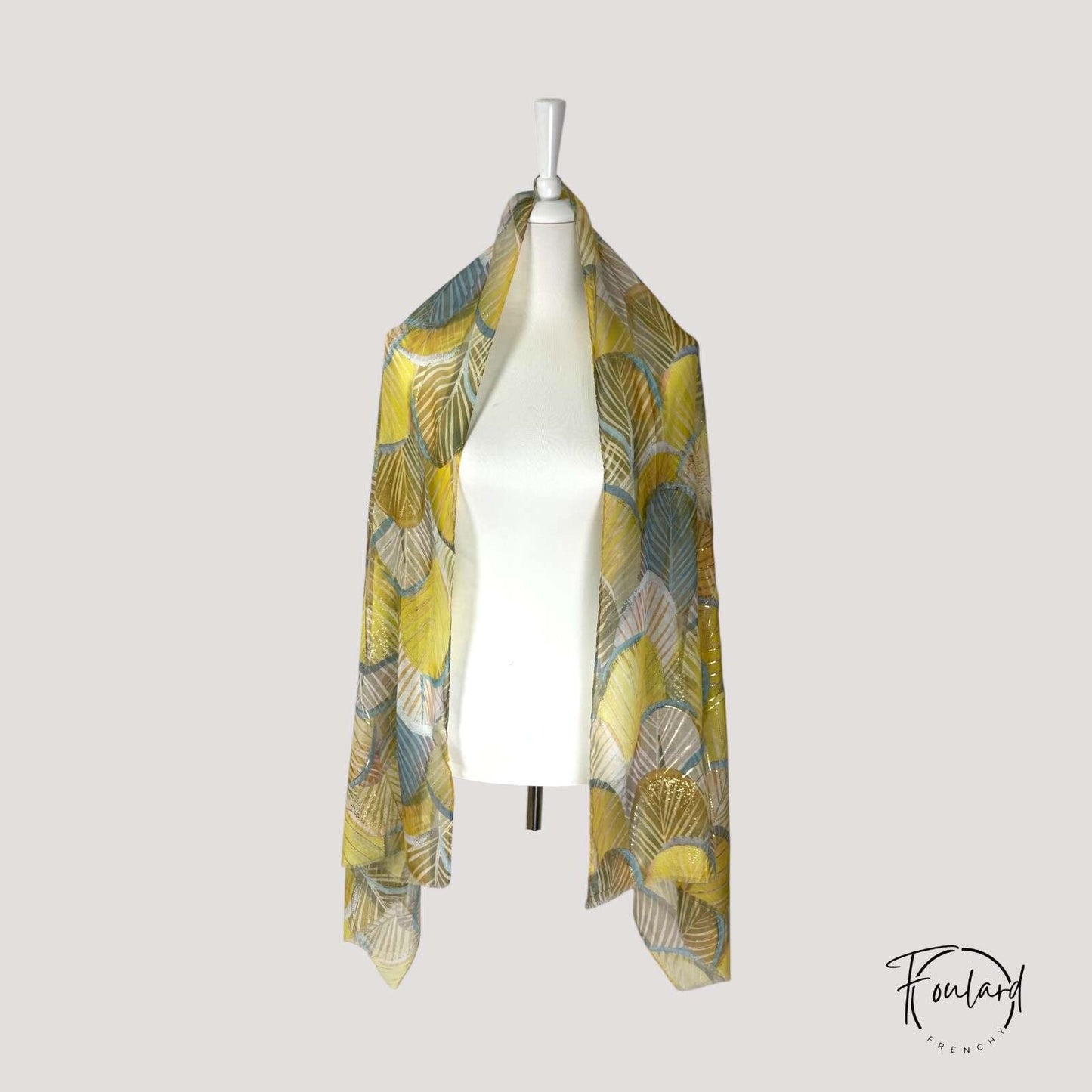 Détail des motifs abstraits dorés et bleus sur le foulard