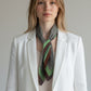 Foulard carré porté autour du cou, motif rétro vert et marron