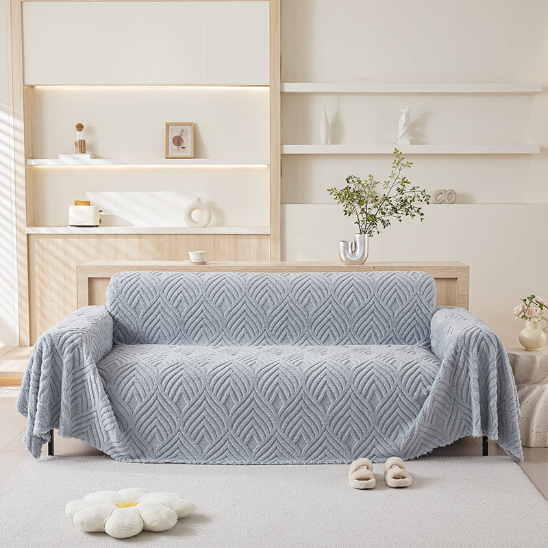Jeté bleu avec motif végétal sur canapé droit