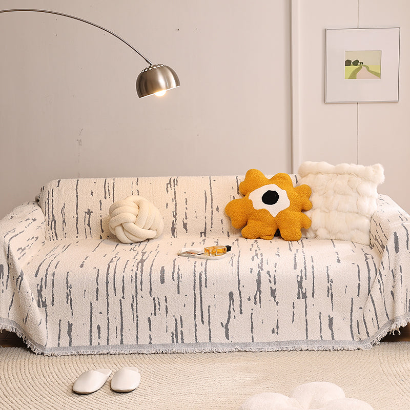 Jeté de canapé en coton gris sur un canapé moderne