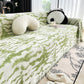 Jeté de canapé vert avec motifs en relief visibles