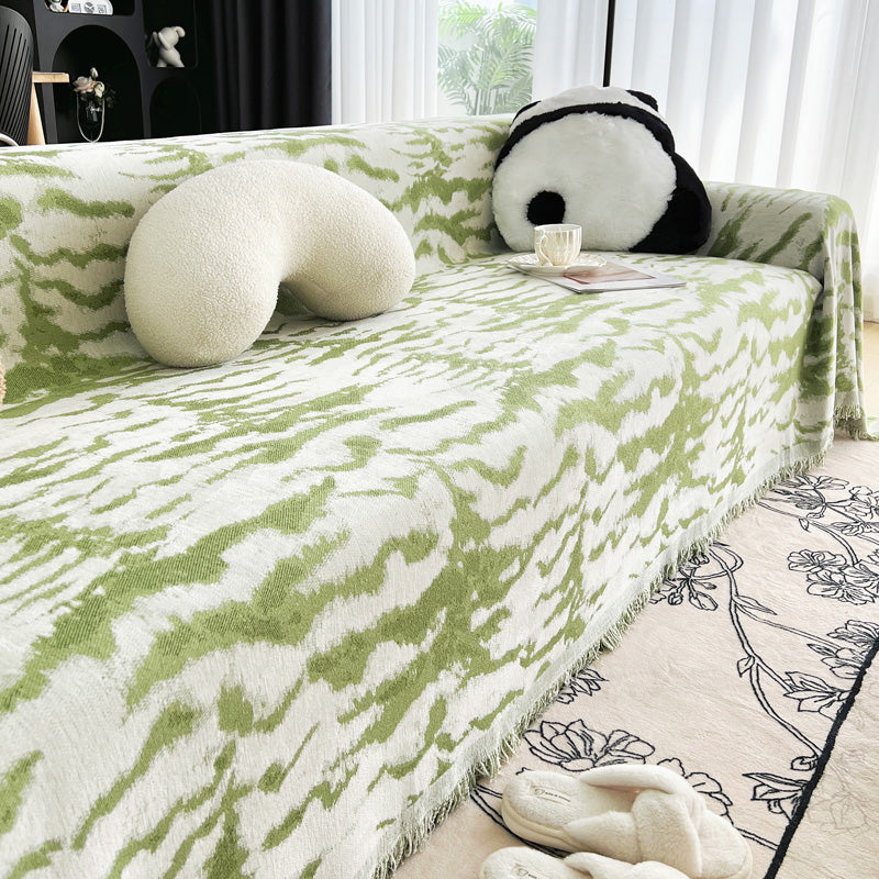 Jeté de canapé vert avec motifs en relief visibles