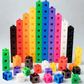 Enfant jouant avec des cubes empilables multicolores sur une table