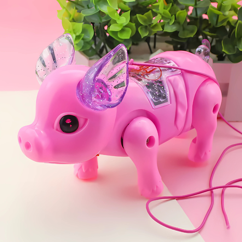 Enfant jouant avec le cochon musical lumineux