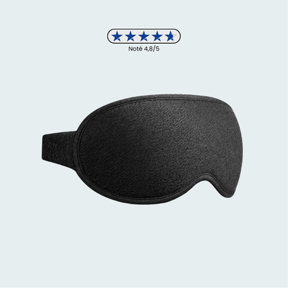 Masque de sommeil noir posé sur une surface claire