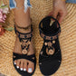 Sandales noires plates avec détails floraux et perles