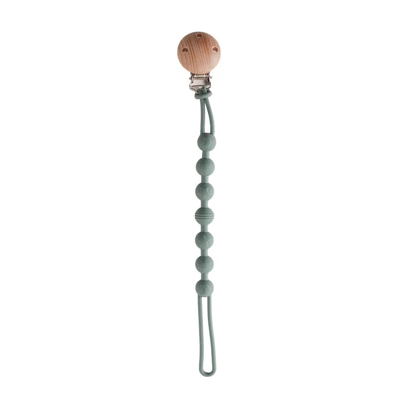 Attache sucette en bois et silicone sur une couverture douce