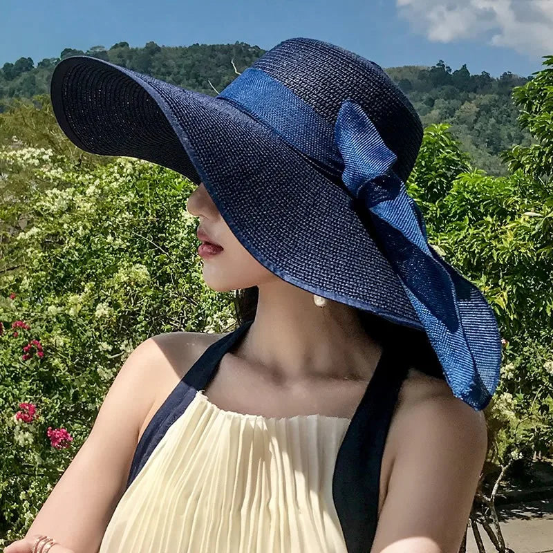 Chapeau de paille avec ruban noir, posé sur une table