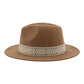 Chapeau fedora beige posé sur une table en bois