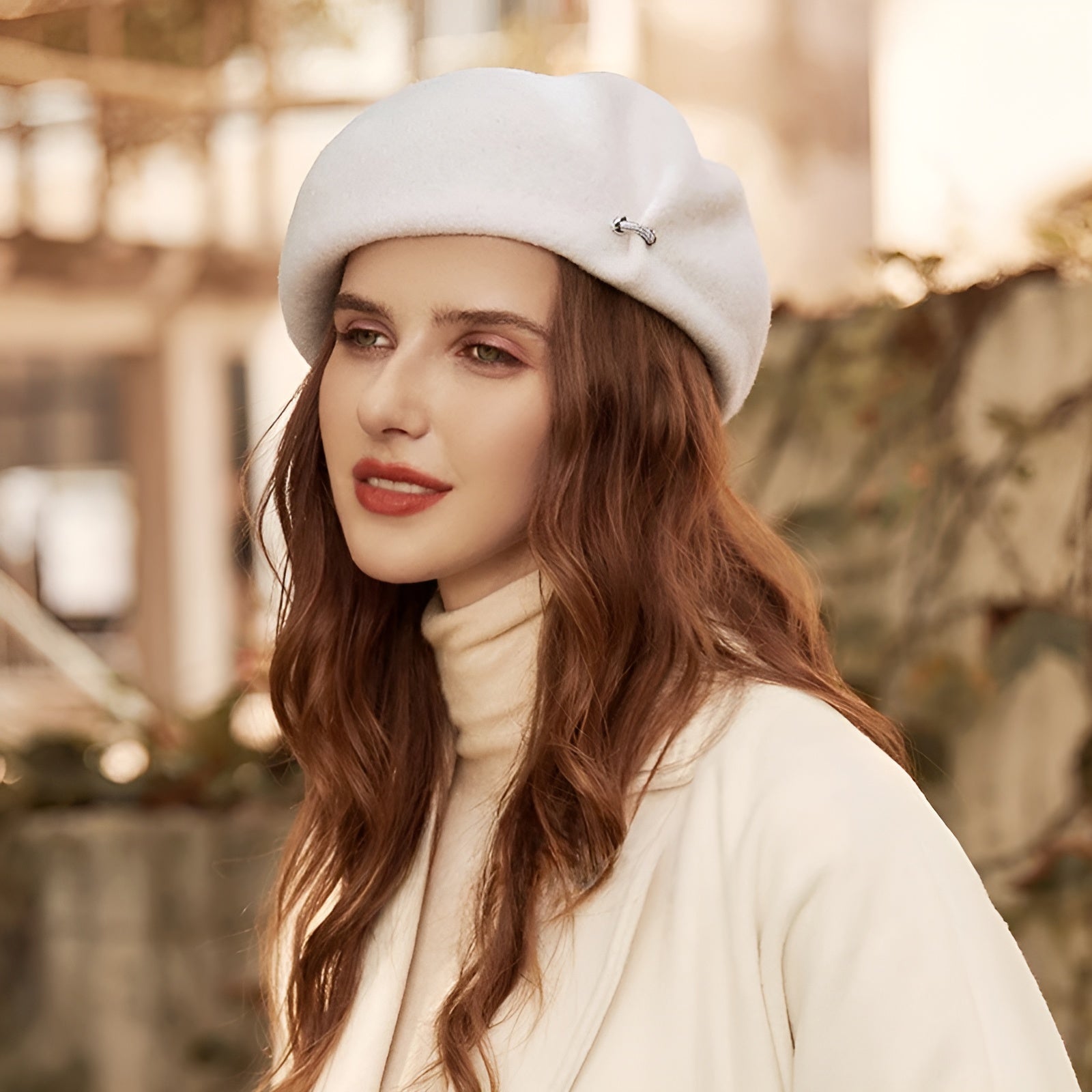 Béret en laine avec broche argentée sur fond blanc