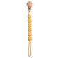 Attache sucette en bois et silicone sur un fond clair