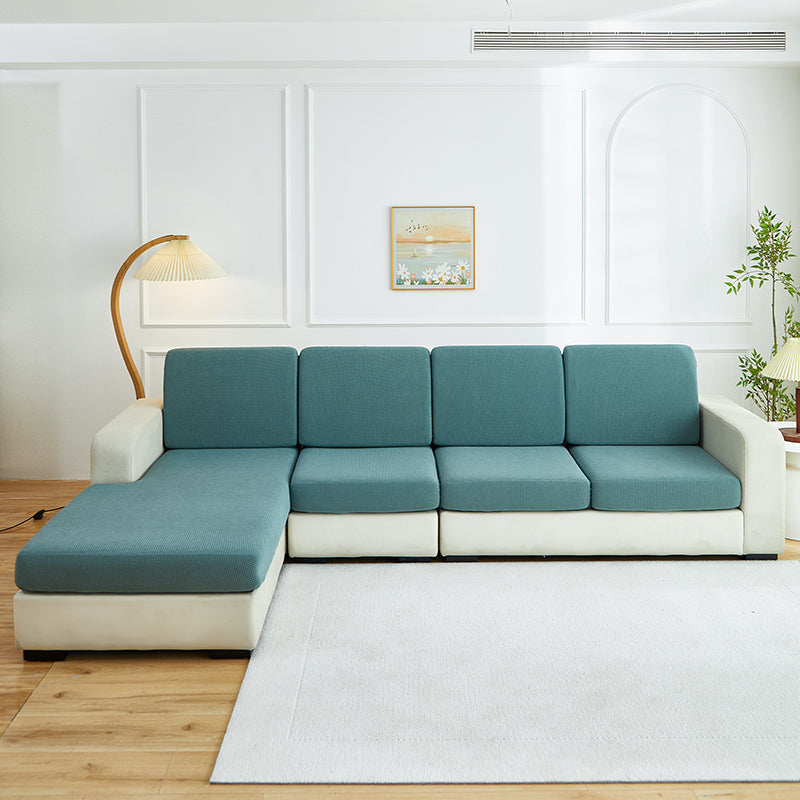 Housse verte sur canapé d'angle, mise en situation