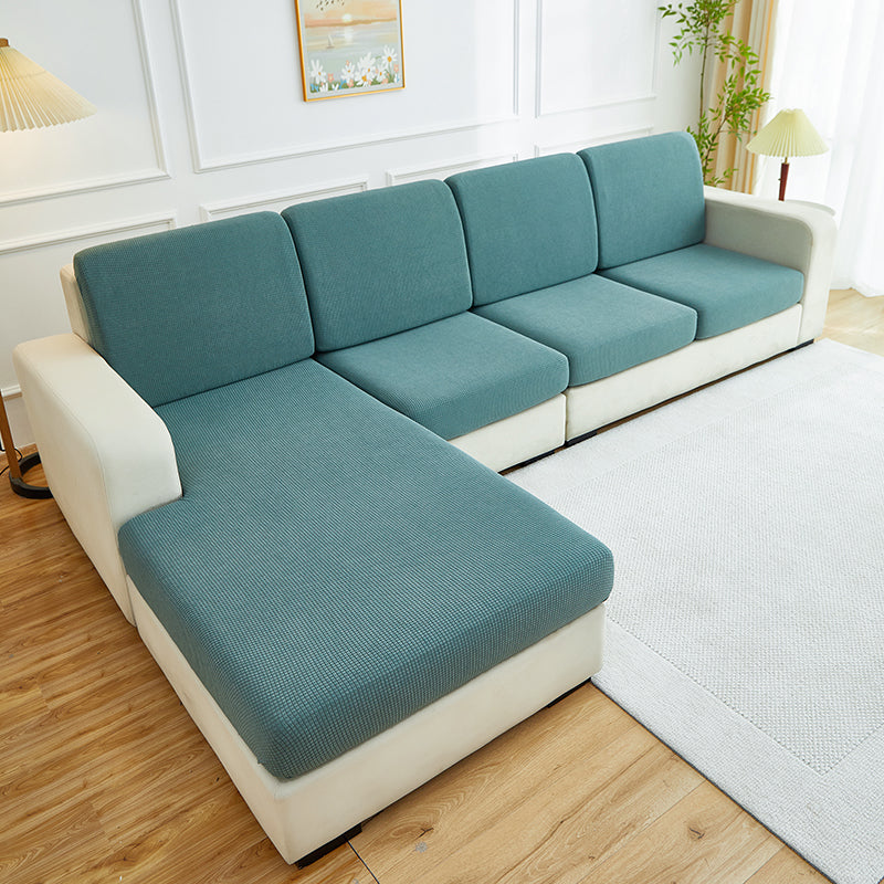Housse déperlante verte sur coussin de canapé, vue de face