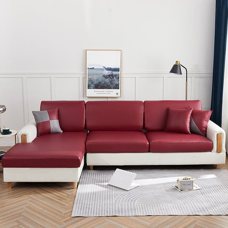 Détail de la housse bordeaux sur un canapé moderne