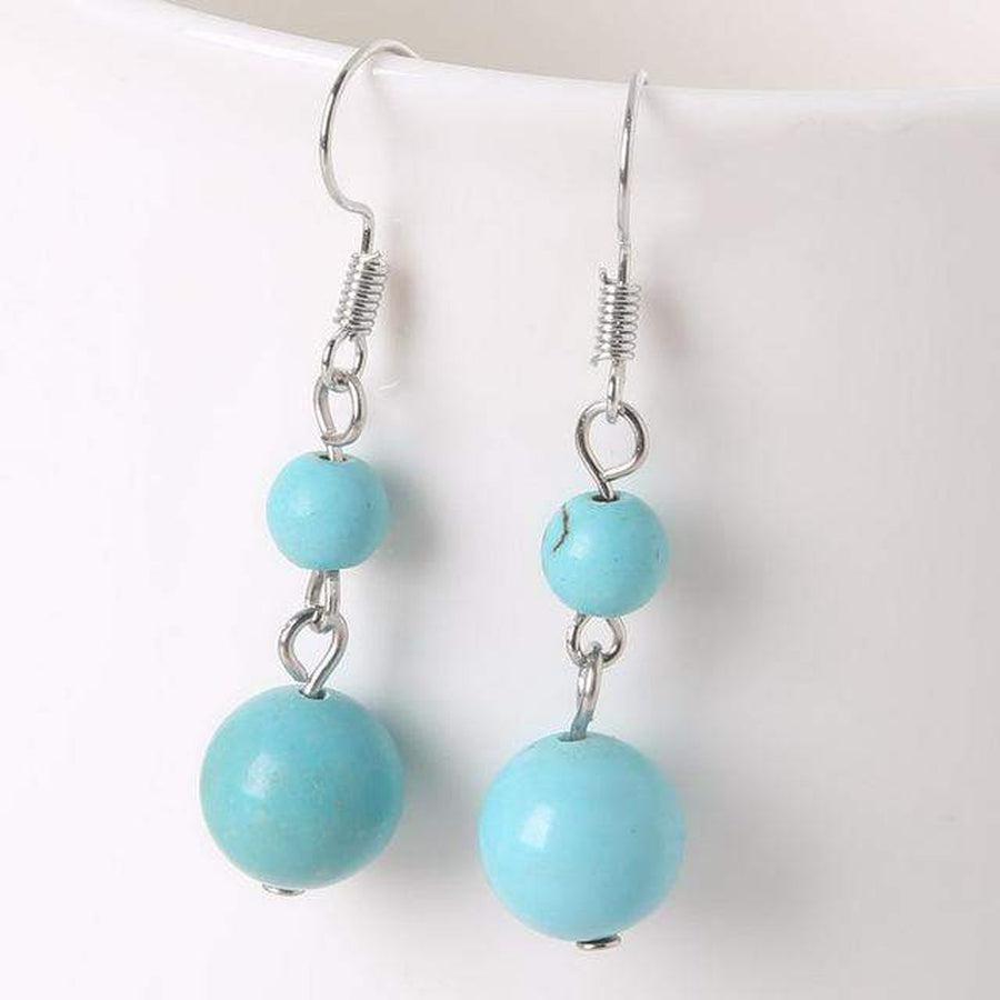 Vue latérale des boucles d'oreilles améthyste, détails des perles