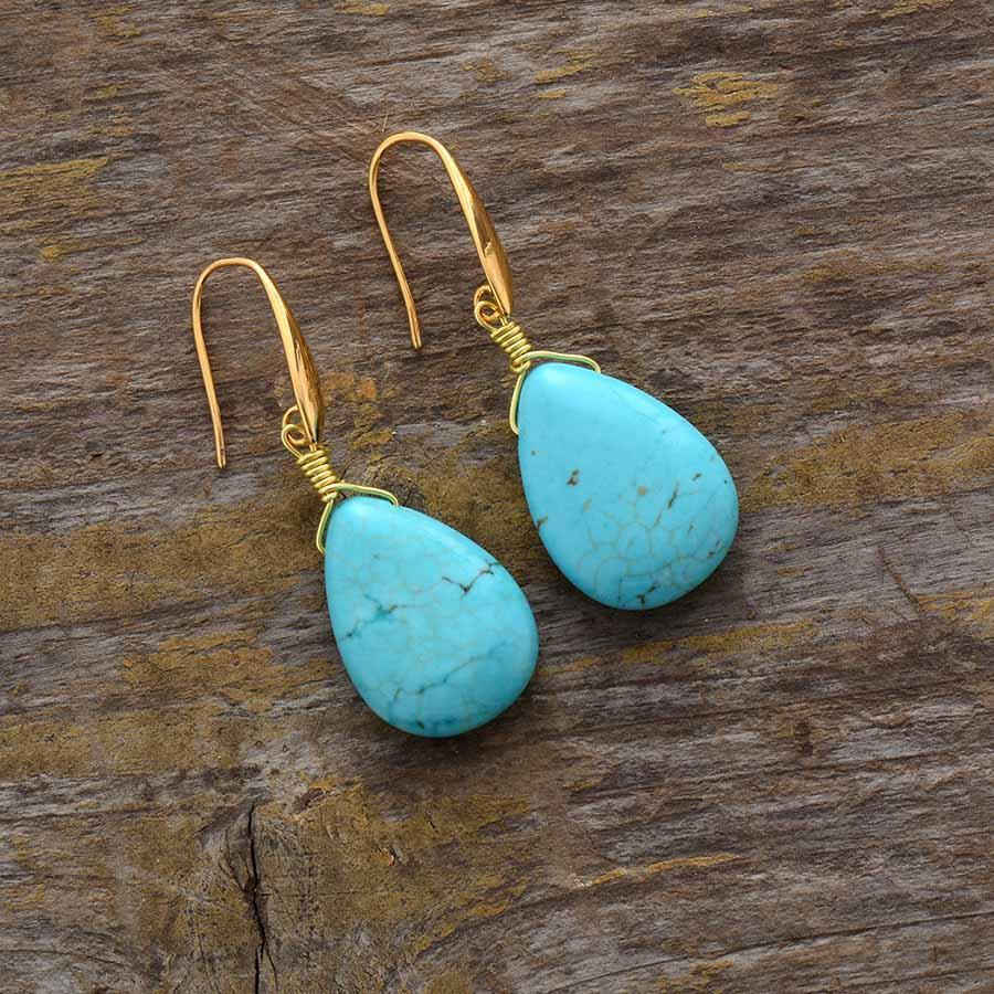 Boucles d'oreilles goutte turquoise sur fond blanc