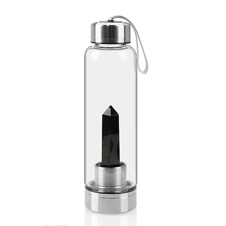 Bouteille en cristal avec pierre visible à travers le verre
