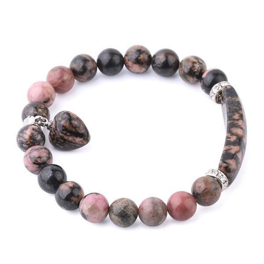 Bracelet en rhodonite sur fond blanc, perles roses et noires