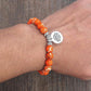 Détail du pendentif lotus sur bracelet calcite orange