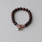 Bracelet en bois avec perles brun foncé et cloche