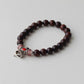 Bracelet de perles en bois avec clochette symbolique